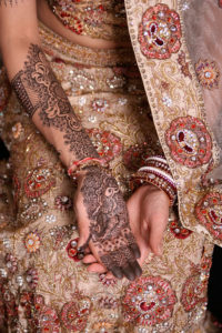 Hindu women apply henna