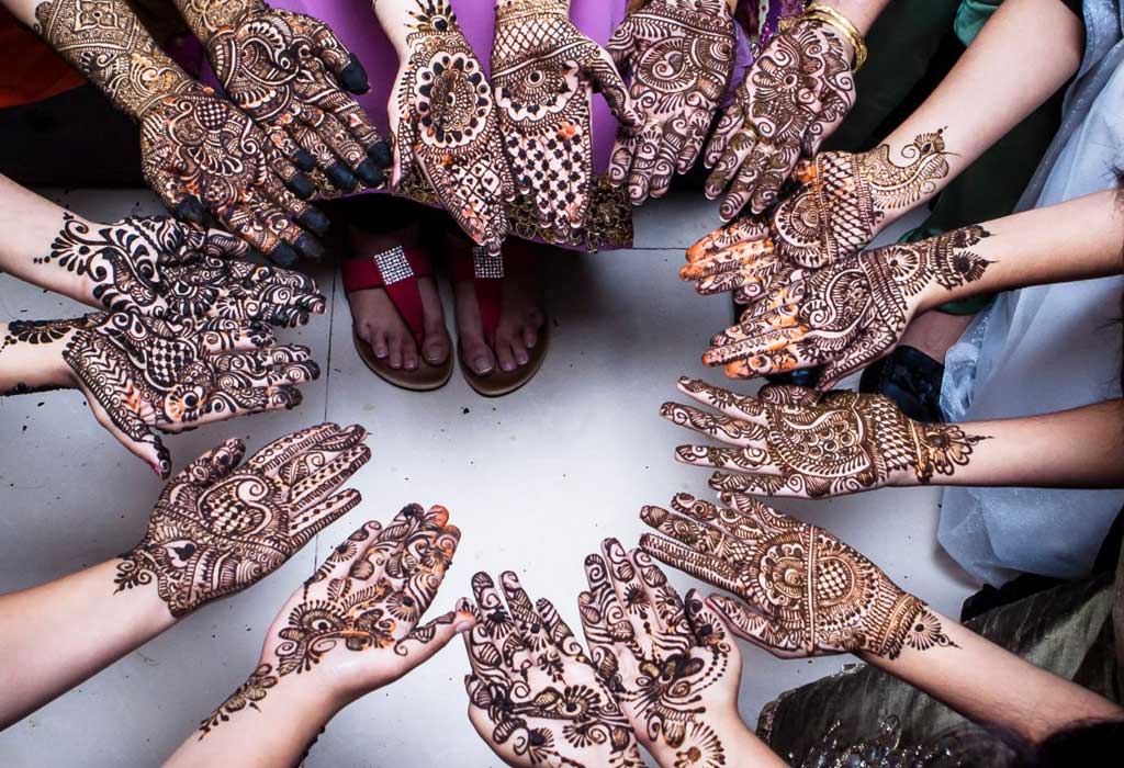 Hindu women apply henna